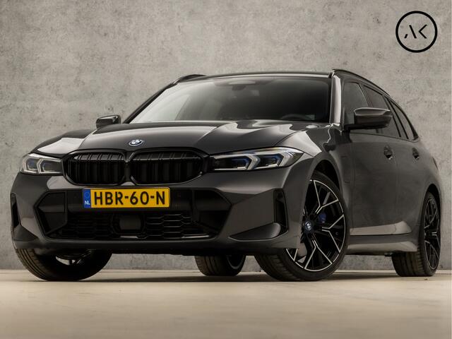 BMW 3-SERIE Touring 330e M-Sport 293Pk Automaat (DRAVITGRAU, FACELIFT, LASER KOPLAMPEN, HEAD-UP DISPLAY, CAMERA, M PAKKET, KEYLESS, MEMORY SEATS, ADAPTIVE CRUISE, SFEERVERLICHTING, APPLE CARPLAY, DAB+, NIEUWSTAAT)