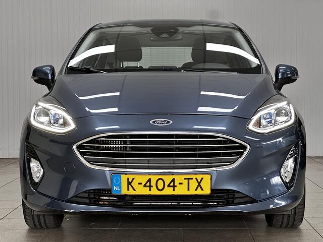 Ford FIESTA 1.0 EcoBoost Titanium/ 15'' LMV/ LED Koplampen/ DAB+/ Lane-Assist./ Clima/ Cruise/ Elek. pakket/ Isofix/ Bluetooth/ Multi. LEDER. Stuur/ Mistl./ PDC/ Chroom/ LED Dagrijverl.