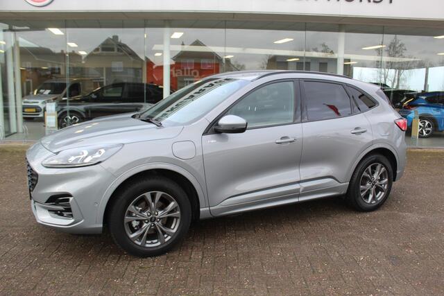 Ford KUGA 2.5-225pk PHEV ST-Line X. 1500kg Trekgewicht Hybride rijden voor een reëel bedrag ! Autm. airco dual, stuur-, stoel-, achterbank- en voorraamverw., keyless entry/keyless go, privacy glass, camera v+a, side- en lane assist, adaptieve cruise cntrl, trekhaak