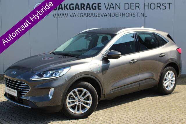Ford KUGA 2.5-225 pk PHEV Titanium X Plug-In Hybrid-Automaat. Hybride rijden voor een reële prijs ! Adapt. Cruise Cntrl, Climate Cntrl, Navigatie, Side- en Lane assist, Telefoonvoorb., Keyless entry/keyless go, Stoel- en voorraamverw., Camera v+a, All season banden