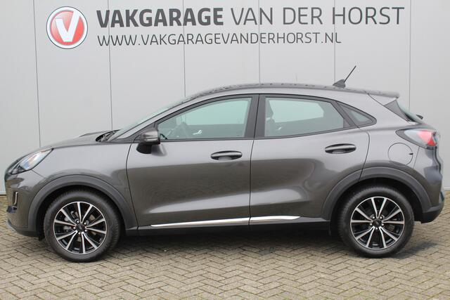 Ford PUMA 1.0-125pk EcoBoost Mild-Hybrid Titanium. Fabrieksgarantie t/m 21-05-2027 ! Slechts 14.800km ! Volautm. airco, pdc achter, all season banden, stoel-, stuur- en voorraamverw., navigatie, telefoonvoorb., elektr. achterklep, cruise cntrl, keyless entry&go etc