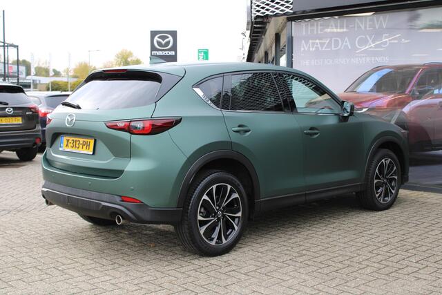 Mazda CX-5 2.0 e-SkyActiv-G M Hybrid 165 Exclusive-Line+Com.P , Automaat, Matte Metallic Pine Green gewrapped, Black Comfort Pack, Navi, Adap.Cruise, Clima, Apple Carplay, 360 Camera, PDC, HUD, Stuur/Stoelverwarming, 19" LMV