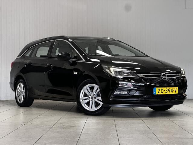 Opel ASTRA Sports Tourer 1.0 Business Executive/ Trekhaak/ 16'' LMV/ Keyless/ Apple + Android/ PDC V+A/ DAB+/ Navi/ Clima/ Cruise/ Elek. pakket/ Isofix/ Bluetooth/ Multi. LEDER. Stuur/ Mistl./ Chroom/ Dakrails.