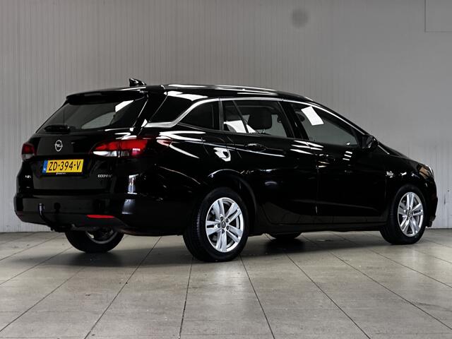 Opel ASTRA Sports Tourer 1.0 Business Executive/ Trekhaak/ 16'' LMV/ Keyless/ Apple + Android/ PDC V+A/ DAB+/ Navi/ Clima/ Cruise/ Elek. pakket/ Isofix/ Bluetooth/ Multi. LEDER. Stuur/ Mistl./ Chroom/ Dakrails.