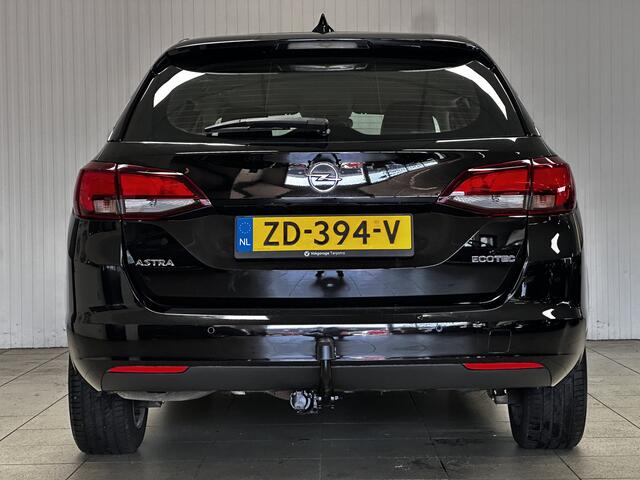 Opel ASTRA Sports Tourer 1.0 Business Executive/ Trekhaak/ 16'' LMV/ Keyless/ Apple + Android/ PDC V+A/ DAB+/ Navi/ Clima/ Cruise/ Elek. pakket/ Isofix/ Bluetooth/ Multi. LEDER. Stuur/ Mistl./ Chroom/ Dakrails.