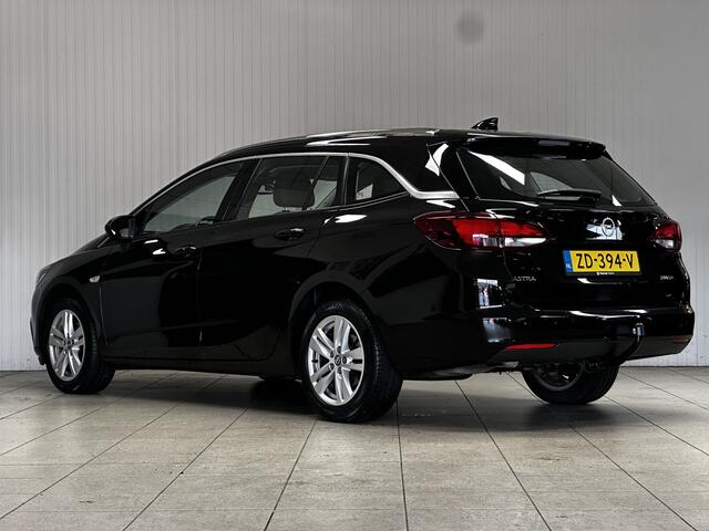 Opel ASTRA Sports Tourer 1.0 Business Executive/ Trekhaak/ 16'' LMV/ Keyless/ Apple + Android/ PDC V+A/ DAB+/ Navi/ Clima/ Cruise/ Elek. pakket/ Isofix/ Bluetooth/ Multi. LEDER. Stuur/ Mistl./ Chroom/ Dakrails.