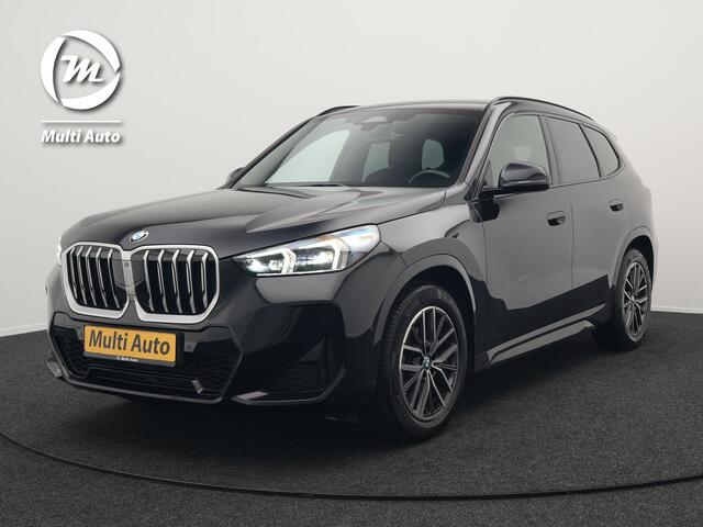 BMW X1 sDrive18i M-Sport Automaat 136pk Dealer O.H. | Trekhaak af Fabriek | Alcantara Sportstoelen Memory & Verwarmd | Camera | Cruise Control | Blis | Park Assist | Apple Carplay | Navigatie | Sfeerverlichting |