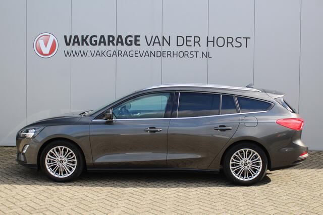 Ford FOCUS Wagon 1.0-125pk EcoBoost Titanium Business. Uiterst nette, comfortabele en ruime stationcar. Stoel-, stuur- en voorraamverw., Trekhaak, B&O soundsyst, lane assist, adaptieve cruise cntrl, camera a, LM wln, navigatie, telefoonvoorb. etc