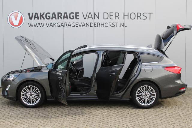 Ford FOCUS Wagon 1.0-125pk EcoBoost Titanium Business. Uiterst nette, comfortabele en ruime stationcar. Stoel-, stuur- en voorraamverw., Trekhaak, B&O soundsyst, lane assist, adaptieve cruise cntrl, camera a, LM wln, navigatie, telefoonvoorb. etc