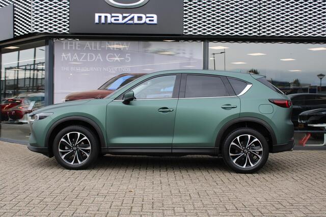 Mazda CX-5 2.0 e-SkyActiv-G M Hybrid 165 Exclusive-Line+Com.P , Automaat, Matte Metallic Pine Green gewrapped, Black Comfort Pack, Navi, Adap.Cruise, Clima, Apple Carplay, 360 Camera, PDC, HUD, Stuur/Stoelverwarming, 19" LMV