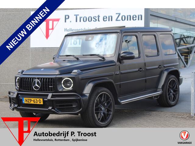 Mercedes-Benz G-KLASSE 63 AMG Night pakket/Magno matt/Panoramadak/Burmester audio/Sfeerverlichting/Entertainment schermen achter/Akrapovic/AMG active ride control/Elektrisch verstelbare stoelen met memory + massage/Stoel verwarming + koeling/360° camera/voorruitverwarming/IWC