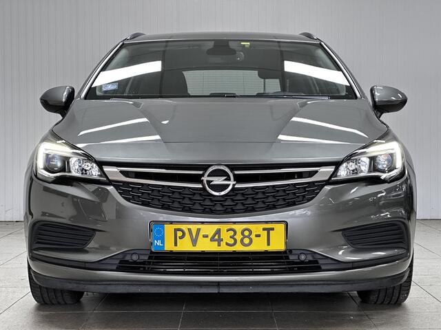 Opel ASTRA Sports Tourer 1.0 Online Edition/ PDC V+A/ Apple + Android/ DAB+/ Navi/ Airco/ Cruise/ Elek. pakket/ Isofix/ Bluetooth/ Armsteun/ Multi. LEDER. Stuur/ LED Dagrijverl.